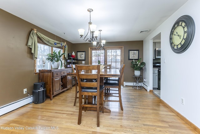dining area with light wood finished floors, an inviting chandelier, visible vents, baseboards, and baseboard heating