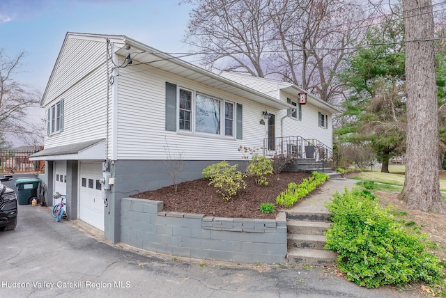 view of front of house featuring a garage and aphalt driveway