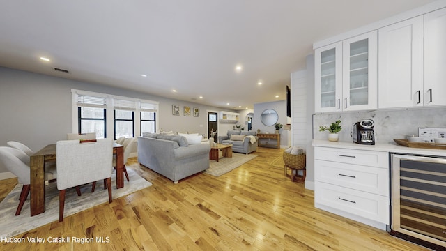 living room featuring light hardwood / wood-style floors and wine cooler