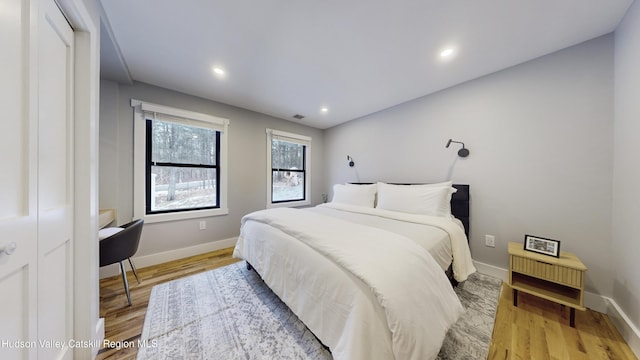 bedroom with a closet and light hardwood / wood-style floors