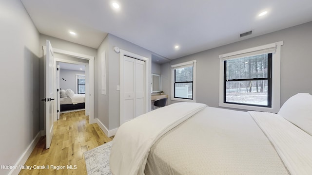 bedroom featuring light hardwood / wood-style floors and a closet