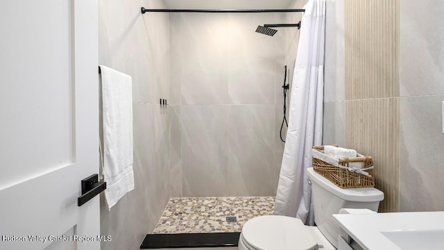 bathroom featuring toilet and walk in shower