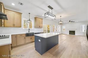 LOT13 Silo Ridge Dr, Wallkill, NY 12589 - kitchen featuring a kitchen island, decorative light fixtures, a fireplace, ceiling fan, and a sink