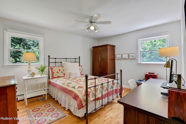 512 Watson Woods Rd, Lake Hill, NY 12448 - bedroom with a baseboard heating unit, light wood-style flooring, a desk, and ceiling fan