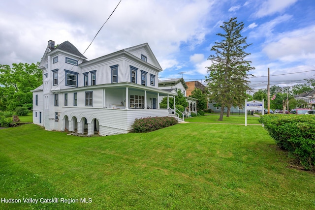 66 Green, Hudson, NY 12534 - view of side of home featuring a chimney, a lawn, and a porch