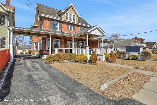 view of front of property with a porch and brick siding