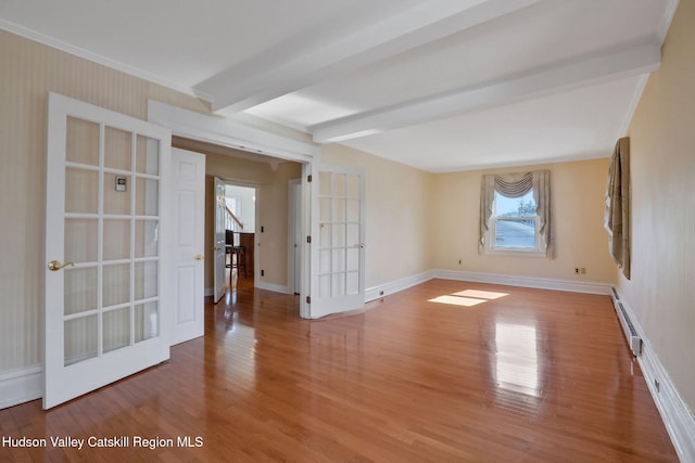 spare room with baseboard heating, wood finished floors, french doors, and beamed ceiling