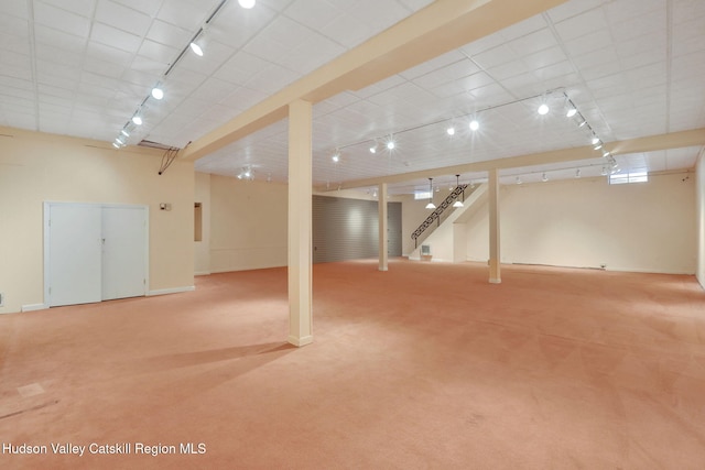 finished basement featuring carpet floors and track lighting