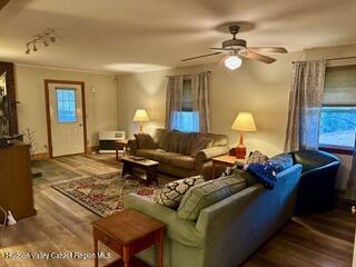 212 S St, Windham, NY 12496 - living room with wood finished floors, ceiling fan, track lighting, and baseboards