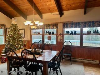 212 S St, Windham, NY 12496 - dining area featuring a baseboard radiator, wood ceiling, wood finished floors, and a chandelier