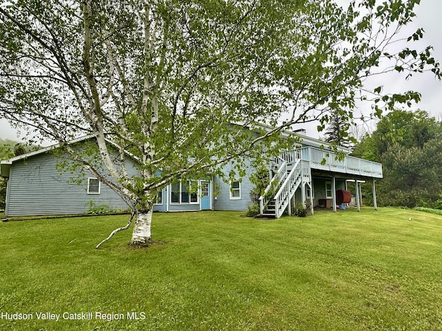 212 S St, Windham, NY 12496 - rear view of house with a wooden deck, stairs, and a lawn