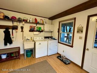 212 S St, Windham, NY 12496 - laundry room featuring cabinet space, washer and dryer, wood finished floors, and baseboards