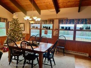212 S St, Windham, NY 12496 - dining room featuring a baseboard heating unit, a chandelier, wood ceiling, and wood finished floors