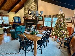 212 S St, Windham, NY 12496 - dining space featuring a fireplace, wood finished floors, wood ceiling with exposed beams, and high vaulted ceiling