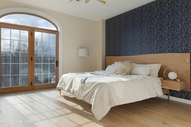 bedroom with ceiling fan and light hardwood / wood-style flooring