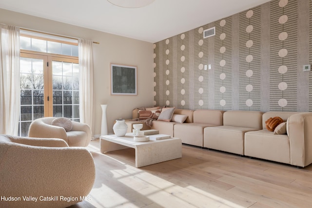 living room featuring french doors and light hardwood / wood-style floors