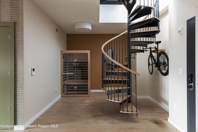 stairs with hardwood / wood-style floors