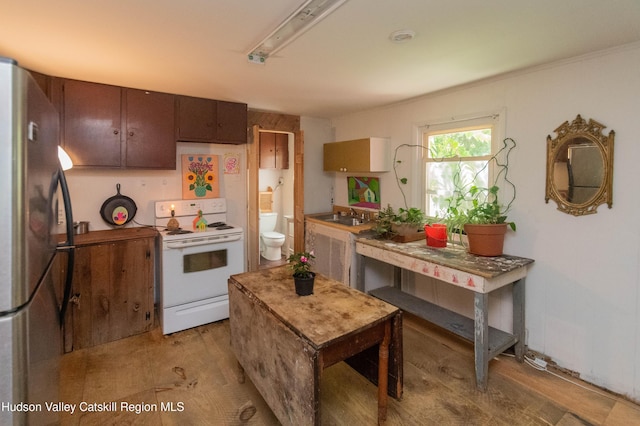 73 Cauterskill Ave, Catskill, NY 12414 - kitchen with electric range, freestanding refrigerator, and light wood-type flooring