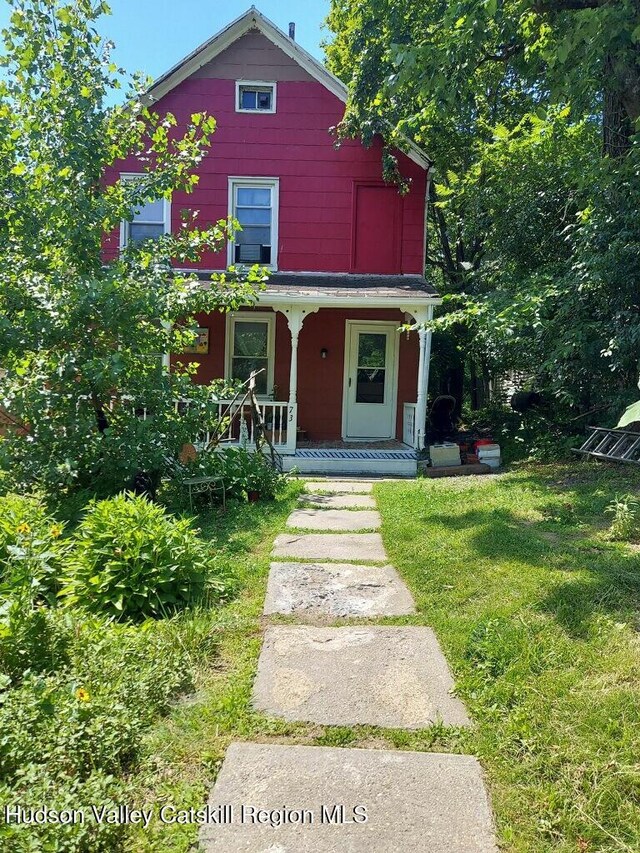 73 Cauterskill Ave, Catskill, NY 12414 - view of front facade featuring covered porch and a front yard