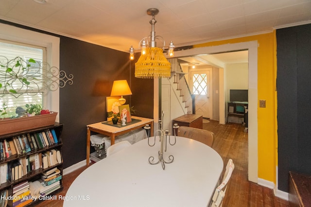 73 Cauterskill Ave, Catskill, NY 12414 - dining area with wood finished floors, crown molding, and stairway