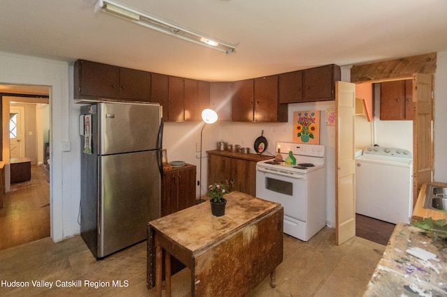 73 Cauterskill Ave, Catskill, NY 12414 - kitchen with freestanding refrigerator, white electric stove, and washer / dryer
