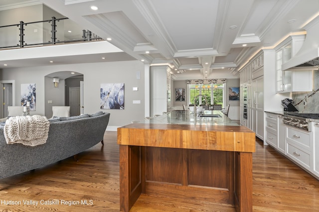 1 Stoneridge Dr, Loudonville, NY 12211 - kitchen with stainless steel gas stovetop, arched walkways, premium range hood, ornamental molding, and wood finished floors