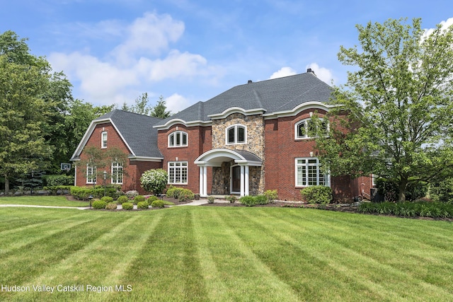 1 Stoneridge Dr, Loudonville, NY 12211 - view of front of house with a front yard, stone siding, and brick siding