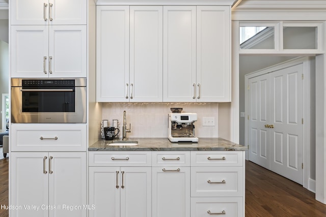 1 Stoneridge Dr, Loudonville, NY 12211 - kitchen with stainless steel oven, stone counters, dark wood-style flooring, backsplash, and white cabinetry