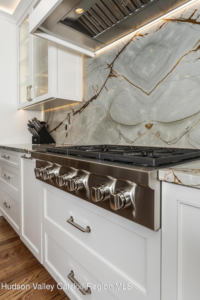 1 Stoneridge Dr, Loudonville, NY 12211 - kitchen view of stainless steel gas stovetop, decorative backsplash, and white cabinetry