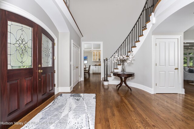 1 Stoneridge Dr, Loudonville, NY 12211 - entrance foyer featuring stairway, arched walkways, and dark wood-type flooring
