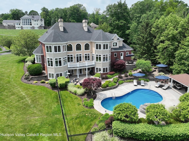 1 Stoneridge Dr, Loudonville, NY 12211 - back of property with a patio area, a yard, a chimney, and an outdoor pool