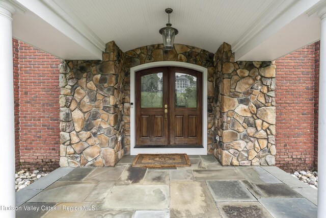 1 Stoneridge Dr, Loudonville, NY 12211 - property entrance featuring stone siding, brick siding, and french doors