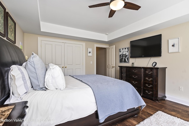 1 Stoneridge Dr, Loudonville, NY 12211 - bedroom with dark wood-style floors, a raised ceiling, a closet, and ceiling fan