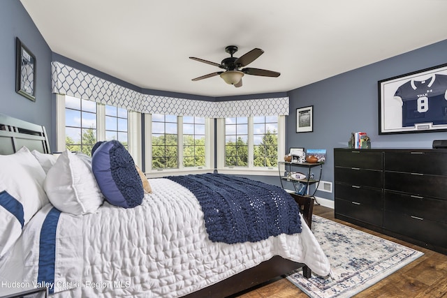 1 Stoneridge Dr, Loudonville, NY 12211 - bedroom with multiple windows, wood finished floors, and a ceiling fan