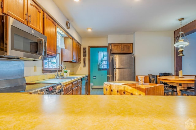 176 High Rock Rd, West Coxsackie, NY 12192 - kitchen featuring appliances with stainless steel finishes, a sink, light countertops, brown cabinetry, and recessed lighting