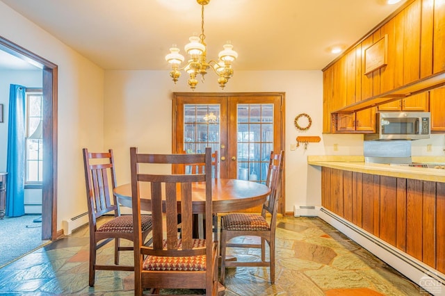 176 High Rock Rd, West Coxsackie, NY 12192 - dining space featuring a baseboard radiator, baseboard heating, a chandelier, and stone tile flooring