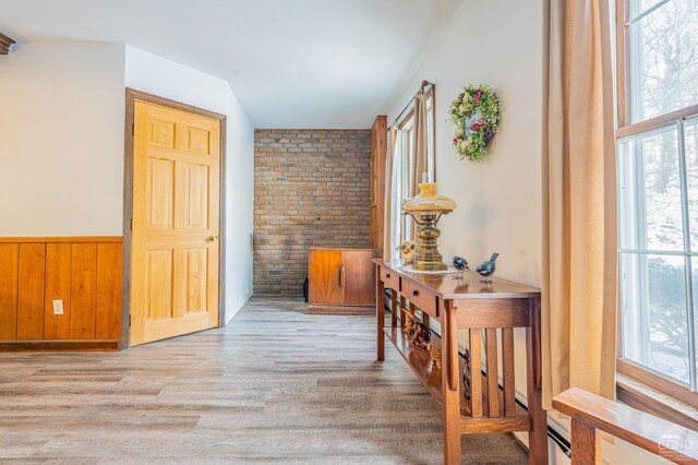176 High Rock Rd, West Coxsackie, NY 12192 - hallway featuring plenty of natural light, wood finished floors, brick wall, a wainscoted wall, and wooden walls
