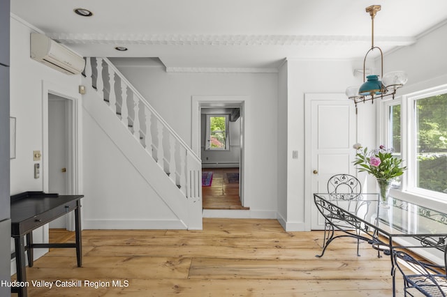 202 Buckwheat Bridge Rd, Germantown, NY 12526 - foyer featuring an AC wall unit, stairs, light wood-style floors, baseboards, and a baseboard heating unit