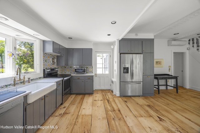 202 Buckwheat Bridge Rd, Germantown, NY 12526 - kitchen with appliances with stainless steel finishes, gray cabinets, a wall unit AC, light wood finished floors, and recessed lighting