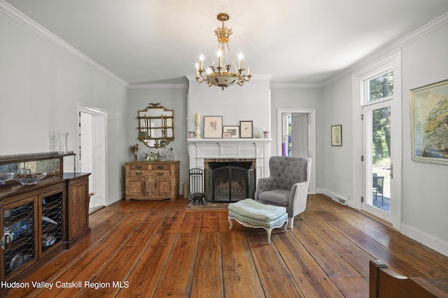 202 Buckwheat Bridge Rd, Germantown, NY 12526 - living area featuring a brick fireplace, a chandelier, hardwood / wood-style floors, ornamental molding, and baseboards