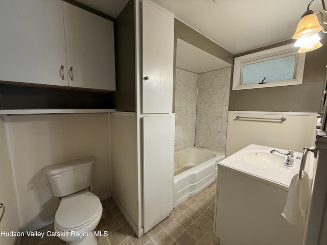 bathroom featuring tile patterned flooring, vanity, and toilet