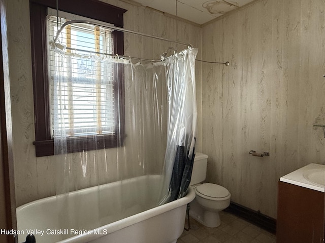 full bathroom featuring toilet, vanity, and shower / tub combo with curtain