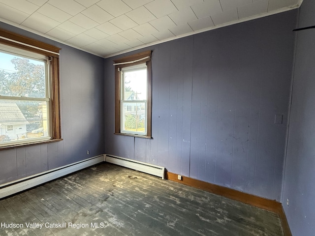 unfurnished room with wooden walls and dark wood-type flooring