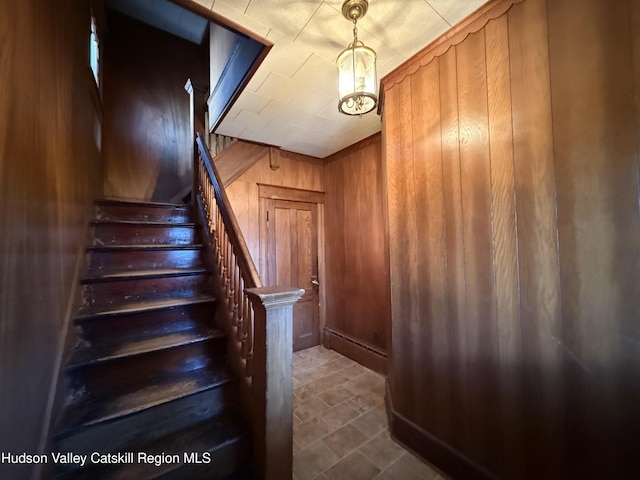 staircase with wooden walls