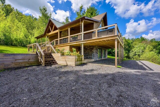 562 New Concord Rd, Chatham, NY 12060 - back of property featuring a deck, stairway, a ceiling fan, a carport, and stone siding