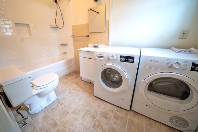 washroom featuring separate washer and dryer and light tile patterned floors