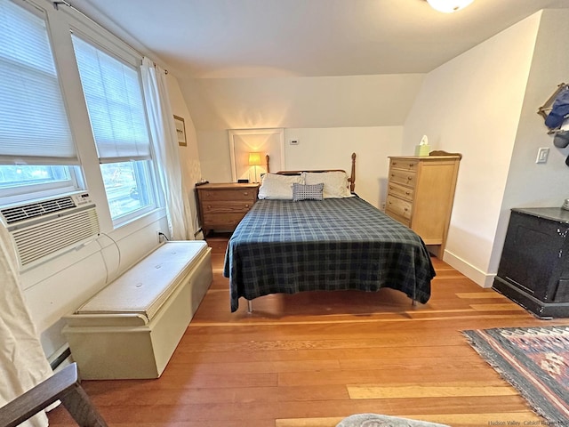 bedroom with lofted ceiling and light hardwood / wood-style flooring