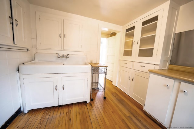 kitchen featuring dark wood-type flooring and white cabinetry