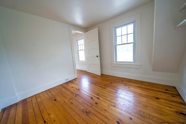 unfurnished room with hardwood / wood-style floors