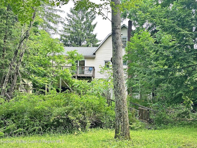 view of side of home featuring a wooden deck